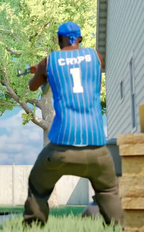 Hood Warfare 2 Crips player in blue number 1 jersey crouching beside a teal sedan on the Suburbs map