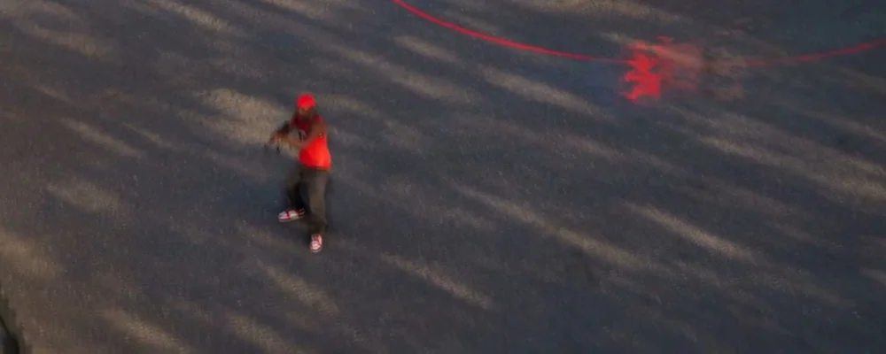 Turf War objective zone in Hood Warfare 2 with a red capture ring across the parking lot